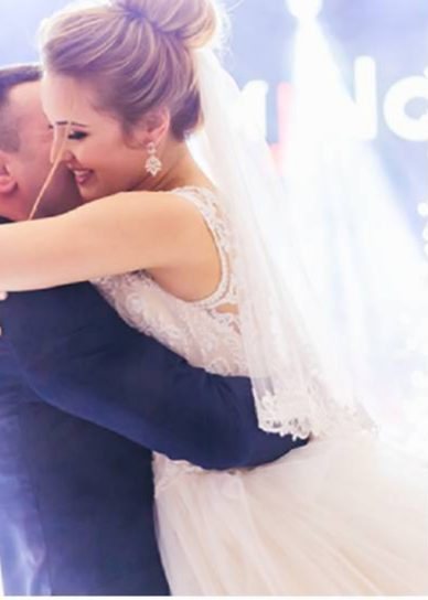 Bride and groom holding each other close